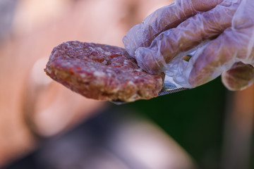Fototapeta premium Juicy cutlets for burgers are roasted on the grill
