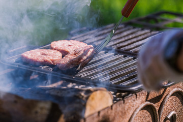 Juicy cutlets for burgers are roasted on the grill