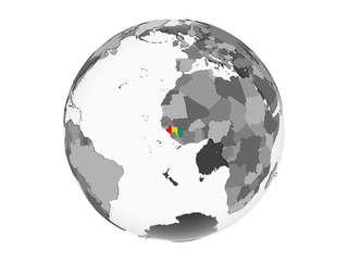Guinea with flag on globe isolated