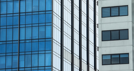 Plakat Modern steel and glass facade for office highrise buildings. Construction underway for the new modern and contemporary skyscraper.