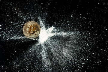 Gold bitcoin sprinkled with cocaine on a black table