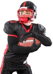 American football player with the ball on stadium background