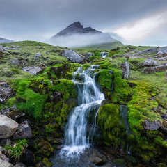Fototapeta na wymiar Beautiful little waterfall near Eiði, Faroe Islands