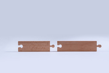 Wooden jigsaw puzzle with blank space. There is a matching puzzle next to it. The concept of solving problems, all problems can be solved, connection.