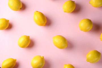 Flat lay composition with fresh ripe lemons on color background