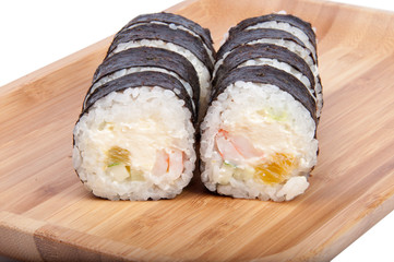 tasty sushi roll on the wooden board background