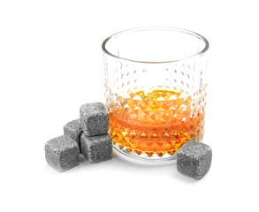 Glass with liquor and whiskey stones on white background