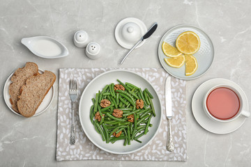 Obraz na płótnie Canvas Flat lay composition with plate of fresh green bean salad on table