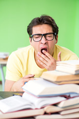 Student with too many books to read before exam