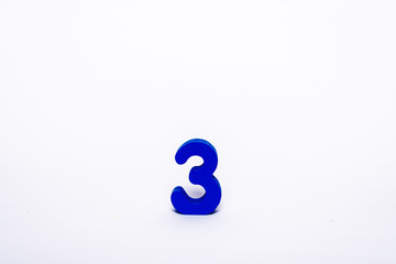 Blue digit 3 isolated on a white background. Wooden number 3 on a white background.