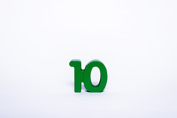 Green digit 10 isolated on a white background. Wooden number ten on a white background.