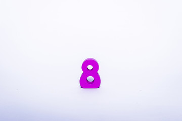 Pink digit 8 isolated on a white background. Wooden number 8 on a white background.