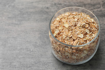 Glass with oatmeal on grey background. Grains and cereals