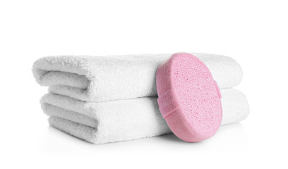 Obraz na płótnie Canvas Stack of clean soft towels and sponge on white background