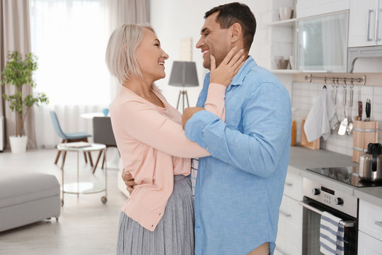 Adorable mature couple dancing together indoors