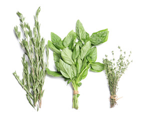 Rosemary, basil and thyme on white background, top view. Aromatic herbs
