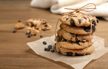 Stack of cookies with chocolate chips on wooden table