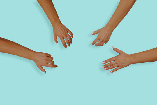 Top View Of Female Hands With Nails On A Blue, Pastel Background. Female Hands Reach For Something In The Middle Of The Table. The Concept Of Desire, The Desire To Receive Something.