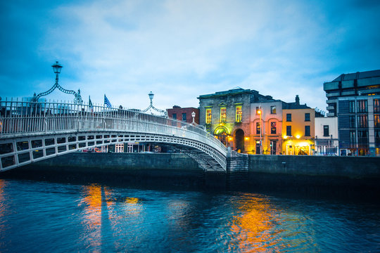 Ha'Penny Bridge over the River Liffey in Dublin Ireland seen a dusk