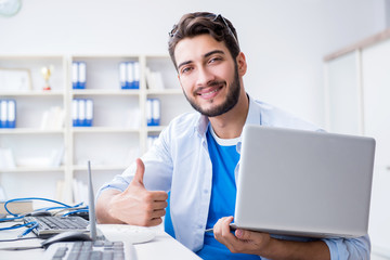 IT technician looking at IT equipment