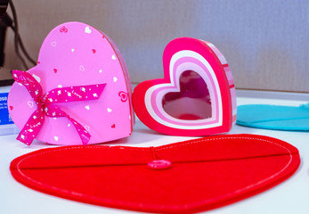 Three red-pink hearts decorating a table