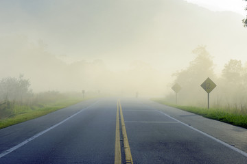 Highway in the morning fog, with motorcycle