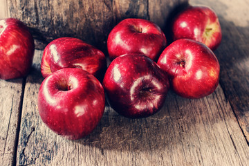 Red apples on old wooden table