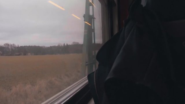 riding the train in a rainy autumn day looking out the window of the countryside