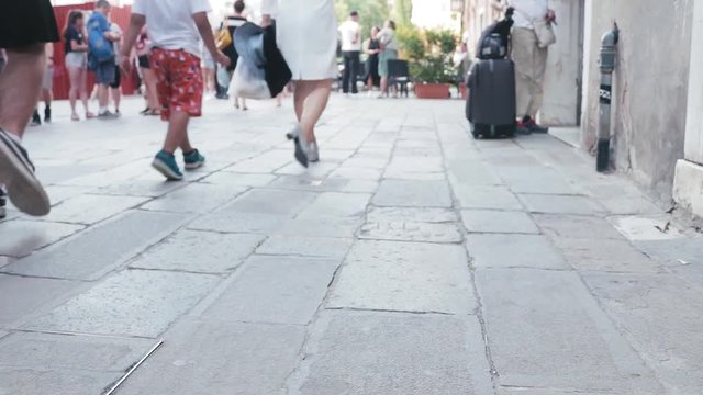 People walking through the streets of Venice.