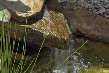 Artificial small fountain, which supplies the garden pond