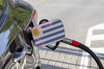 Fueling car with petrol pump at a gas station.
