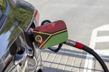Fueling car with petrol pump at a gas station.
