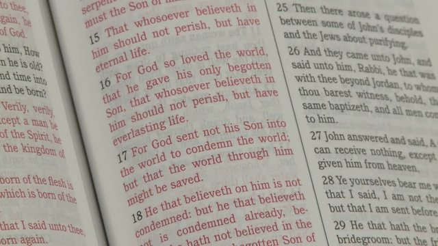 Starting off of the pages this shot pans directly to John 3:16 and 17.