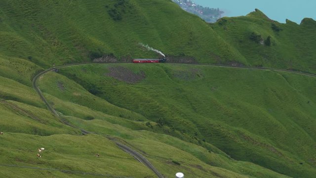 vintage steam train on a mountain track puffing smoke old train locomotive tourism attraction in the swiss alps brienzer rothorn