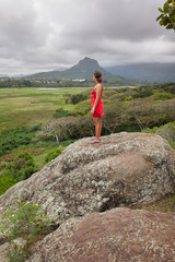 Woman in a red dress on a mountain top in Hawaii