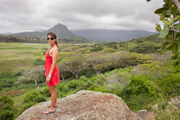 Woman in a red dress on a mountain top in Hawaii