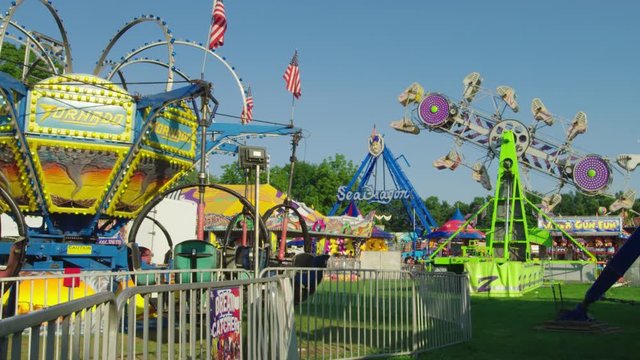 A colorful display at a carnival in a local suburban country fair. Fun rides everywhere.