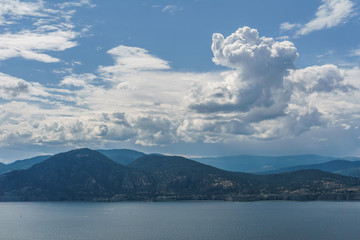 Okanagan lake at summer day with clouds on the sky.
