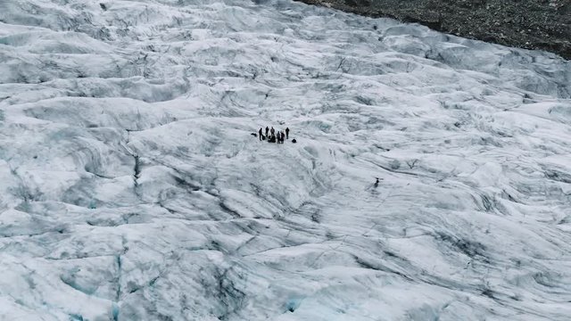 Jostedalsbreen/Nigardsbreen glacier, Norway. Shows two different groups of ice climbers/glacier hikers standing on the center of the glacier, while the video is panning out. Filmed with DJI Mavic Air.
