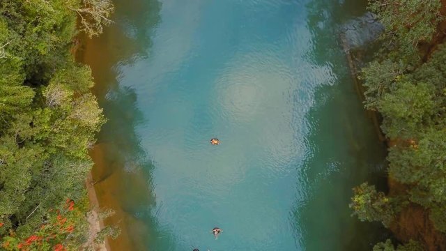Tourists floating on Cahabon River at Semuc Champey, Guatemala, AERIAL TOP VIEW