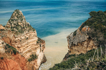 Beautiful views of the Atlantic Ocean and the rocks off the coast of Portugal next to the city called Lagos. Amazing natural landscape.