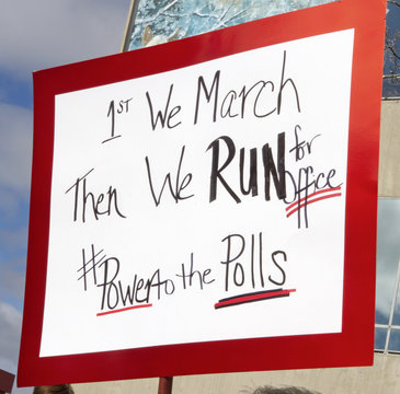 First We March, Then We Run For Office, Says Sign Held By Women