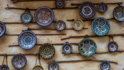 Artistically designed plates hanging in the wall as decoration.