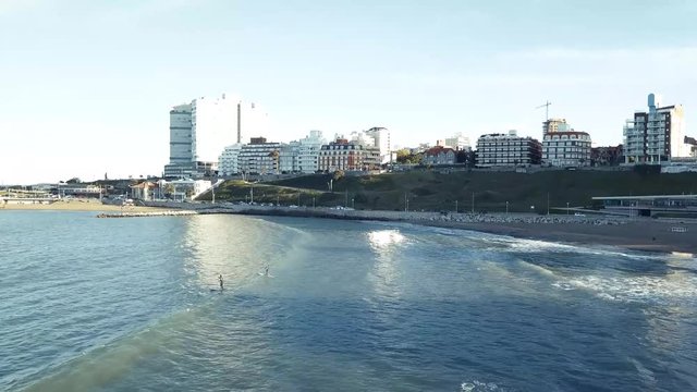 SUP Paddleboard at Playa Varese on the coast of Mar del Plata Argentina – 4k drone video of the Argentinian coast Mar del Plata Casino Central in spring.  Buenos Aires Capital Federal district  