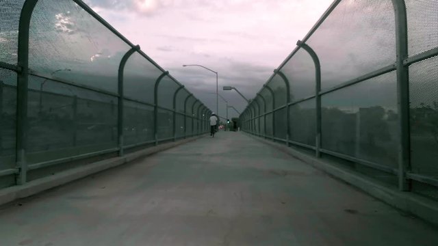 Overpass Walkway with a Storm Coming and a Biker pedestrian