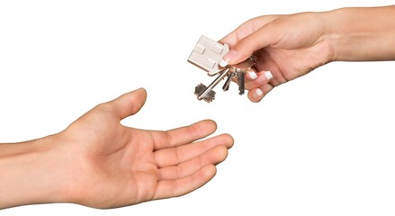 Hands Passing House Keys
