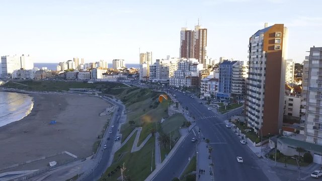 Parasail at Playa Varese on the coast of Mar del Plata Argentina – 4k drone video of the Argentinian coast Mar del Plata Casino Central in spring.  Buenos Aires Capital Federal district  