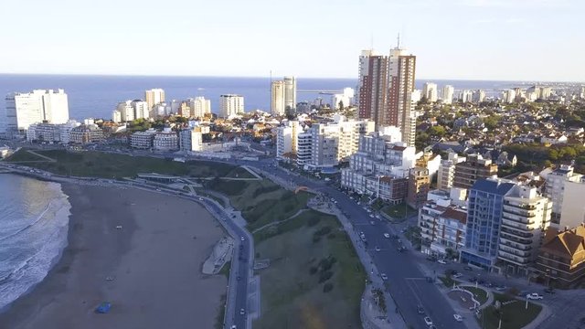 Parasail at Playa Varese on the coast of Mar del Plata Argentina – 4k drone video of the Argentinian coast Mar del Plata Casino Central in spring.  Buenos Aires Capital Federal district  