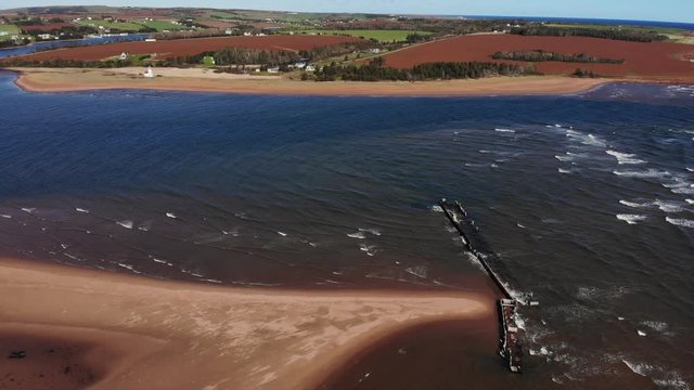 Water channel; beach front with broken dock and country landscape