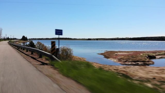 Driving alongside shimmering waterway